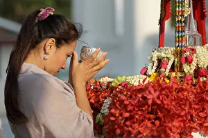 Pour Prints: thai woman pouring water on buddha statue for songkran festival ceremony