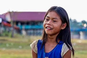 Thakhek, Laos - April 19 2018: Local girl smiling in a remote village in the countryside of Laos