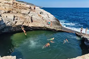 Thassos Prints: Thassos, Greece - July 20, 2019: Tourists are doing diving in the natural swimming pool Giola in Thassos island