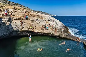 Thassos Prints: Thassos, Greece - July 20, 2019: Tourists are doing diving in the natural swimming pool Giola in Thassos island