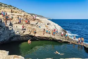 Thassos Prints: Thassos, Greece - July 20, 2019: Tourists are doing diving in the natural swimming pool Giola in Thassos island