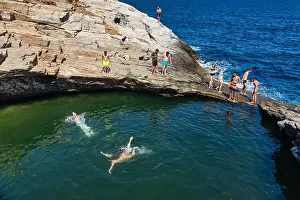 Thassos, Greece - July 20, 2019: Tourists are doing diving in the natural swimming pool Giola in Thassos island, Greece