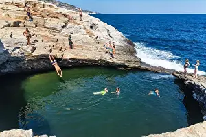 Thassos Prints: Thassos, Greece - July 20, 2019: Tourists are doing diving in the natural swimming pool Giola in Thassos island