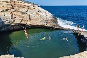 Thassos Prints: Thassos, Greece - July 20, 2019: Tourists are doing diving in the natural swimming pool Giola in Thassos island