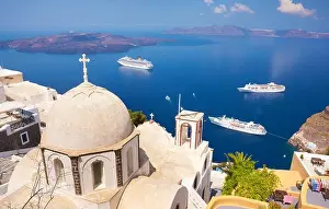 Thira (capital city of Santorini) - greek white church overlooking the cruise ship on Aegean Sea, Santorini Island, Greece