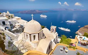 Thira (capital city of Santorini) - greek white church overlooking the cruise ship on Aegean Sea, Santorini Island, Greece