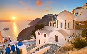 Fira Prints: Thira (capital city of Santorini) - landscape with greek white church and sunset over the sea