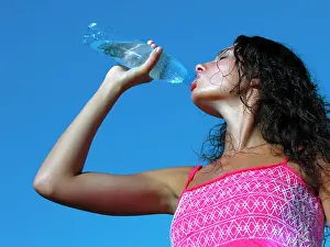 Sweat Prints: Thirst. Young woman drinking cold water in hot day