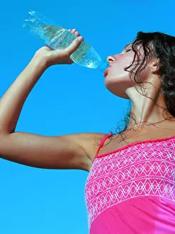 Sweat Prints: Thirst. Young woman drinking cold water in hot day