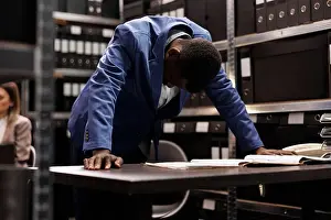 Evidence Prints: Thoughtful detective working in arhive room