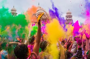 Frolic Prints: Thousands of people throw colored powder into the air during the Holi Festival of Colors at the Sri Sri Radha Krishna