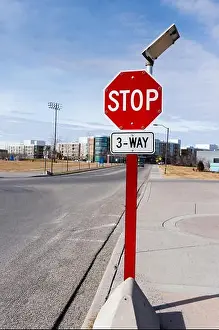 Stop Sign Prints: Three-way solar-powered traffic stop sign in a residential neighborhood with tiny light bulbs around the sign that