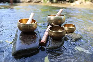 Practicing Prints: Tibetan singing bowls with mallets on stones in river