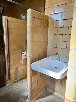 Holder Prints: Tiled vintage public restroom with sink, stalls, toilet paper