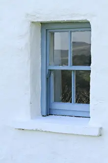 Whitewashed Prints: A timber sash window in a traditional Irish farm cottage near Lauragh