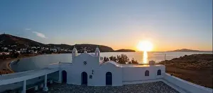 Whitewashed Prints: Tinos island, Cyclades Greece. Aerial drone view of Agios Sostis whitewashed orthodox church at sunset