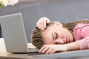 Pout Prints: tired woman in front of a laptop computer in a kitchen