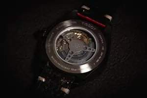 Wristwatch Prints: The Tissot Watch case back with a mechanism behind a glass of the iron case on a leather background