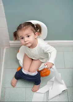 Airy Prints: Toddler girl potty training holding toilet paper in bathroom