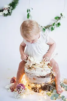 Barefoot Prints: Toddler girl sitting on cake