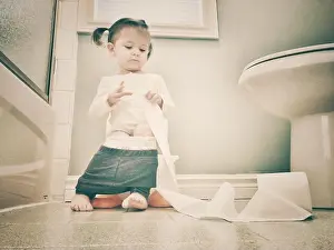 Airy Prints: Toddler girl sitting on potty playing with roll of toilet paper