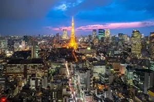 Tokyo city skyline view and office business building skyscraper downtown center with Tokyo Tower at evening in Japan. Asia tourism, modern city life