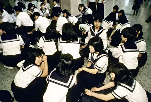 1987 Prints: tokyo japan japanese school children wearing the nationwide identical uniform wait for a train at tokyo station