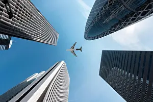 Shinjuku Prints: Tokyo skyscrapers buildings and a plane flying overhead at in Tokyo Shinjuku downtown