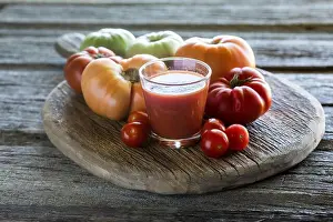 Plump Prints: Tomato juice with heirloom and cherry tomatoes on a rustic wooden board