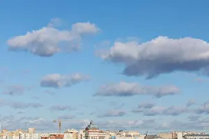 Engineering Equipment Prints: tops of city roofs and construction crane over blue cloudy sky