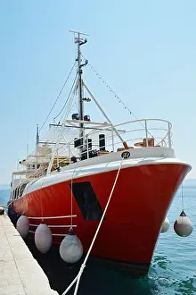 Anchored Prints: Tourist boat anchored in the port