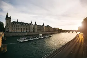 Tourist boat tour on Seine river with beautiful sunset in Paris. Cruise ship sightseeing along river in Paris, France