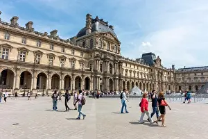 Local Attraction Prints: Tourist on the Cour Napoléon (courtyard) with Richelieu Wing in background