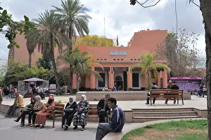 Benches Prints: Tourist office building with people sitting on benches in front, Marrakech, Morocco
