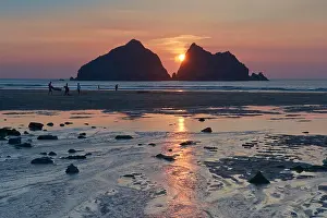 Tourists on the beach at sunset at Holywell Bay - Cornwall, England, UK