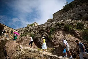 Acropolis Prints: Tourists climb the path up to the Acropolis in Athens