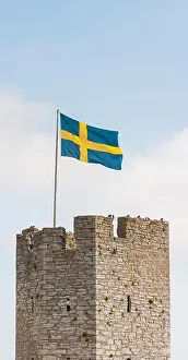 City Wall Prints: Tower of the Visby city wall and the Swedish flag, Gotland, Sweden. Scandinavia