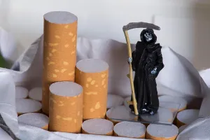 Cigarettes Prints: Toy grim reaper on a packet of cigarettes - concept smoking kills