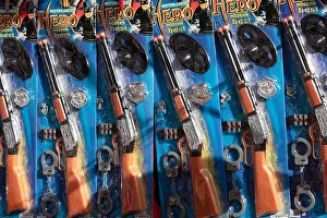 Guns Prints: Toy rifles on sale at a stall at the fiesta de Sana Sebastian in Adeje