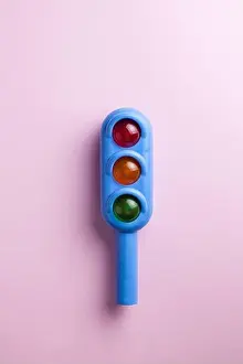 Bookshelf Prints: Toy traffic light close-up on a colored background