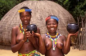 Traditional bare breasted Zulu girls wearing beads