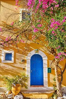 Traditional greek house with bougainvillea blooming flowers, Assos village, Kefalonia Island, Greece