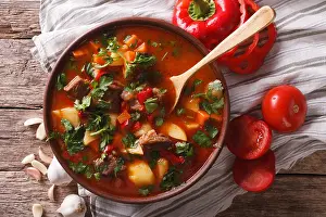 Gravy Prints: Traditional Hungarian goulash soup bogracs close-up in a bowl on the table