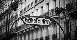 January Collection: Traditional and iconic Paris metro (metropolitain) sign with parisian apartment block in