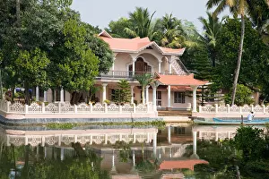 Balconies Prints: Traditional Indian house beside a river in Kerala, India