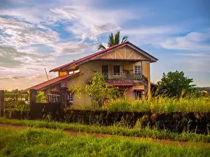 Sky Clouds Prints: Traditional Indian village house surrounded by green grass and beatiful sunset sky