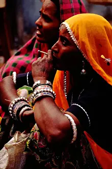 Rajasthani Prints: Traditional Rajasthani Woman smoking biddi at Pushkar Mela Rajasthan India