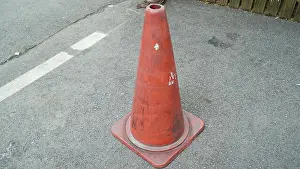 Traffic Cone with White Horizontal Stripe Paint Erased on the Asphalt Side Walk