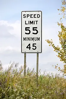 Assist Prints: Traffic sign on the interstate freeway showing maximum and minimum speed limits on the same sign