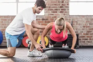 Working Out Prints: Trainer motivating client doing push ups